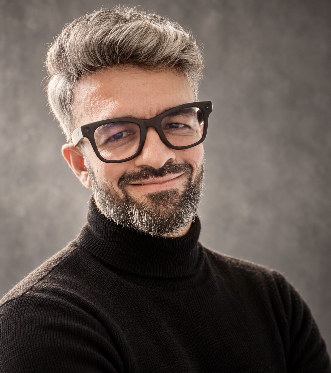 Sarf wearing glasses and a black turtleneck
